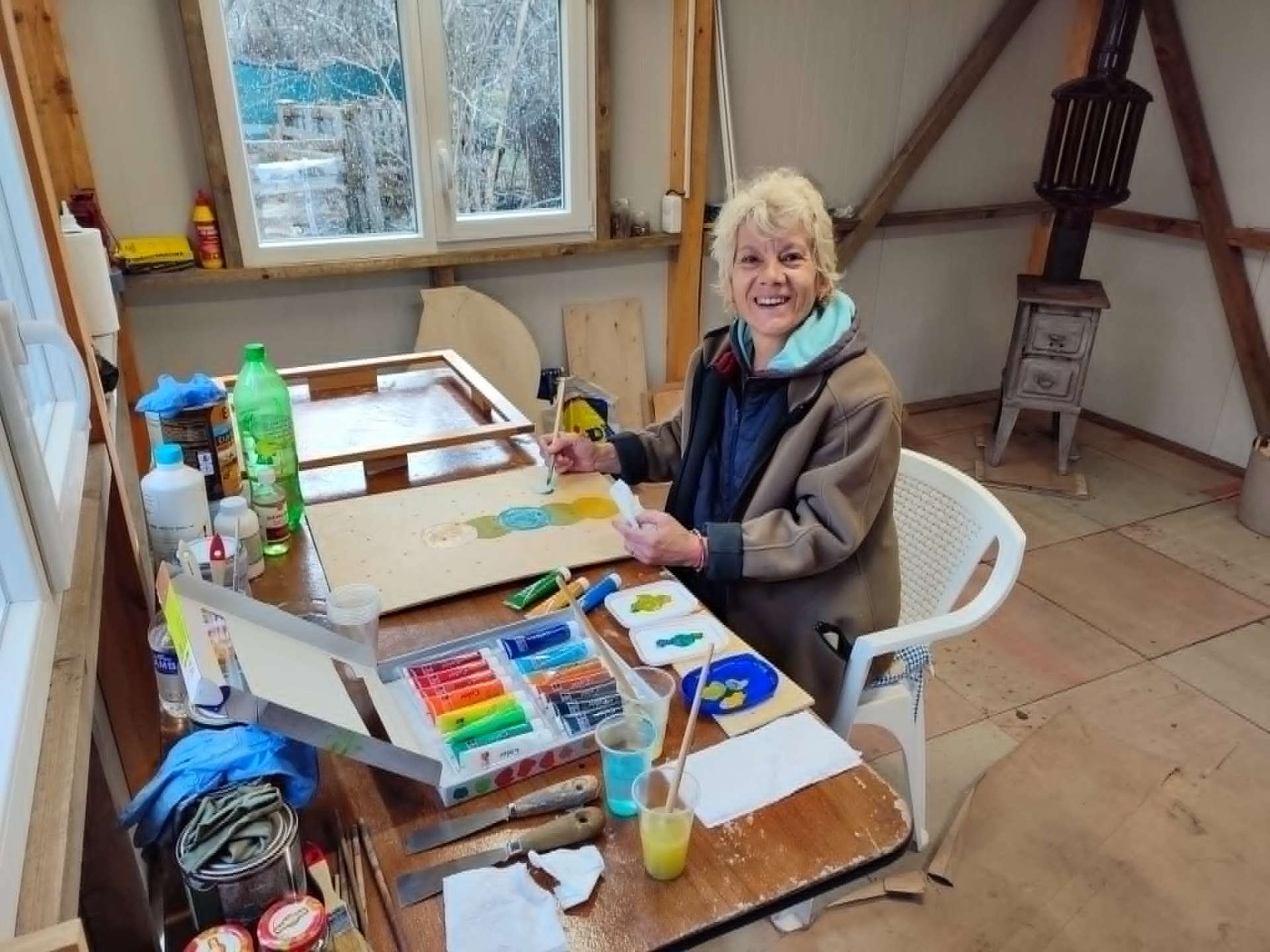 MossArtum co-founder painting moss panel details in the studio