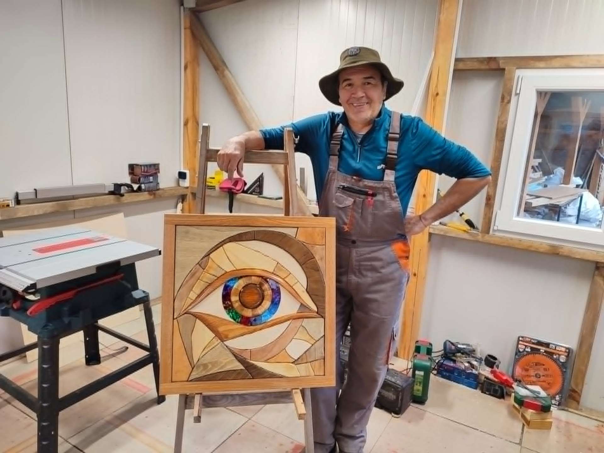 MossArtum co-founder with a hand-carved intarsia eye panel